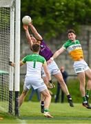 22 May 2022; Niall Hughes of Wexford scores his side's second goal despite the best efforts of Offaly goalkeeper Paddy Dunican and Jordan Hayes during the Tailteann Cup Preliminary Round match between Wexford and Offaly at Bellefield in Enniscorthy, Wexford. Photo by Brendan Moran/Sportsfile