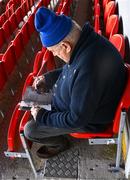 22 May 2022;  An early arrival reads his programme before the Munster GAA Hurling Senior Championship Round 5 match between Clare and Waterford at Cusack Park in Ennis, Clare. Photo by Ray McManus/Sportsfile