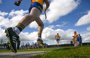 22 May 2022; Cathal Malone, 10, and David Fitzgerald of Clare, left, run out for the start, as the Waterford players disperse after their team photograph, ahead of the Munster GAA Hurling Senior Championship Round 5 match between Clare and Waterford at Cusack Park in Ennis, Clare. Photo by Ray McManus/Sportsfile