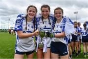 22 May 2022; Waterford players, from left, captain Ruby Browne, Treasa Ni Chrotiagh and Summer Peters celebrate with the cup after the 2022 All-Ireland U14 Silver Final between Tyrone and Waterford at the GAA National Games Development Centre in Abbotstown, Dublin. Photo by Ben McShane/Sportsfile