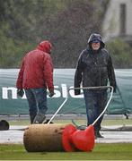 23 May 2022; Ground staff work on the field during a rain delay at the Cricket Ireland Inter-Provincial Cup match between North West Warriors and Leinster Lightning at Eglinton Cricket Club in Derry. Photo by Ramsey Cardy/Sportsfile