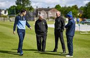 23 May 2022; Umpires Mark Hawthorne, second left, and Roly Black, in conversation with team captains George Dockrell of Leinster Lightning and Andy McBrine of North West Warriors during a rain delay at the Cricket Ireland Inter-Provincial Cup match between North West Warriors and Leinster Lightning at Eglinton Cricket Club in Derry. Photo by Ramsey Cardy/Sportsfile