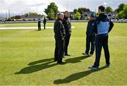 23 May 2022; Umpires Mark Hawthorne, left, and Roly Black, in conversation with team captains George Dockrell of Leinster Lightning and Andy McBrine of North West Warriors during a rain delay at the Cricket Ireland Inter-Provincial Cup match between North West Warriors and Leinster Lightning at Eglinton Cricket Club in Derry. Photo by Ramsey Cardy/Sportsfile