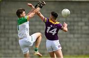 22 May 2022; Offaly goalkeeper Paddy Dunican punches the ball clear of Eoghan Nolan of Wexford during the Tailteann Cup Preliminary Round match between Wexford and Offaly at Bellefield in Enniscorthy, Wexford. Photo by Brendan Moran/Sportsfile