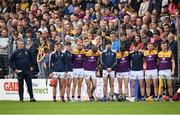 21 May 2022; Wexford manager Darragh Egan and substitutes stand for the playing of the National Anthem before the Leinster GAA Hurling Senior Championship Round 5 match between Kilkenny and Wexford at UPMC Nowlan Park in Kilkenny. Photo by Stephen McCarthy/Sportsfile