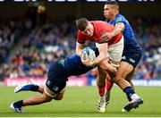 21 May 2022; Jack O'Donoghue of Munster is tackled by Scott Penny, left, and Adam Byrne of Leinster during the United Rugby Championship match between Leinster and Munster at Aviva Stadium in Dublin. Photo by Brendan Moran/Sportsfile