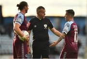 23 May 2022; Referee Ray Matthews with Drogheda United players Keith Cowan, left, and Dylan Grimes during the SSE Airtricity League Premier Division match between Drogheda United and Shamrock Rovers at Head in the Game Park in Drogheda, Louth. Photo by Ben McShane/Sportsfile