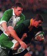 28 November 1998; Adrian Garvey of South Africa is tackled by Keith Wood and Malcolm O'Kelly of Ireland during a International Friendly Match between Ireland and South Africa at Landsdowne Road in Dublin. Photo by Brendan Moran/Sportsfile