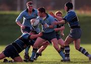 12 December 1998: Ciaran Scally of UCD is tackled by  Frank Butler, left, and Nick Tuwhangua of Corinthians during the AIB All Ireland League Division 3 match between UCD and Corinthians at Belfield in Dublin. Photo by Ray McManus/Sportsfile