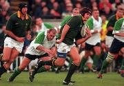 28 November 1998; Johan Erasmus of South Africa slips past the tackle of Peter Clohessy of Ireland on his way to scoring a try during a International Friendly Match between Ireland and South Africa at Landsdowne Road in Dublin. Photo by Brendan Moran/Sportsfile