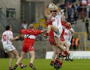 9 May 2004; Joe McMahon, Tyrone, claims a high ball from Fergal Doherty, Derry, as Johnny McBride, 12, Derry, and Brian Dooher, 10, Tyrone, await the breaking ball. Bank of Ireland Ulster Senior Football Championship, Tyrone v Derry, St. Tighernach's Park, Clones, Co. Monaghan. Picture credit; Damien Eagers / SPORTSFILE