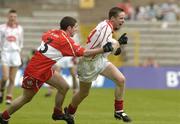 9 May 2004; Cathal McCaron, Tyrone, in action against Mick Shaw, Derry. Ulster Minor Football Championship, Tyrone v Derry, St. Tighernach's Park, Clones, Co. Monaghan. Picture credit; Pat Murphy / SPORTSFILE