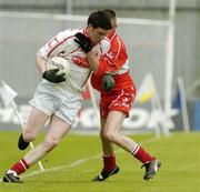 9 May 2004; Marc Cunningham, Tyrone, in action against Ryan Scott, Derry. Ulster Minor Football Championship, Tyrone v Derry, St. Tighernach's Park, Clones, Co. Monaghan. Picture credit; Pat Murphy / SPORTSFILE