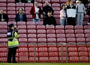 16 April 2004; A member of the Garda videotapes Shamrock Rovers supporters before the start of the game. eircom league, Premier Division, Bohemians v Shamrock Rovers, Dalymount Park, Dublin. Picture credit; David Maher / SPORTSFILE
