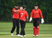 27 May 2022; Liam McCarthy of Munster Reds and PJ Moor of Munster Reds celebrate with Curtis Campher of Munster Reds after he takes his sides fourth wicket of the game during the Cricket Ireland Inter-Provincial Trophy match between Leinster Lightning and Munster Reds at North Down Cricket Club, Comber in Down. Photo by George Tewkesbury/Sportsfile