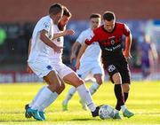 27 May 2022; Liam Burt of Bohemians in action against Gary Deegan and Luke Heeney of Drogheda United during the SSE Airtricity League Premier Division match between Bohemians and Drogheda United at Dalymount Park in Dublin. Photo by Michael P Ryan/Sportsfile