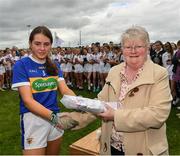 21 May 2022; The Tipperary captain Sinéad Lonergan is presented with the runner up medals by Geraldine Carey, LGFA Management, after the theLadies Football U14 All-Ireland Gold Final match between Kildare and Tipperary at Crettyard GAA in Laois. Photo by Ray McManus/Sportsfile