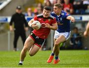 28 May 2022; Daniel McGuinness of Down in action against Killian Clarke of Cavan during the Tailteann Cup Round 1 match between Cavan and Down at Kingspan Breffni in Cavan. Photo by Oliver McVeigh/Sportsfile