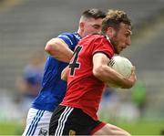 28 May 2022; Barry O'Hagan of Down in action against Killian Brady of Cavan during the Tailteann Cup Round 1 match between Cavan and Down at Kingspan Breffni in Cavan. Photo by Oliver McVeigh/Sportsfile