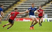28 May 2022; Killian Clarke of Cavan in action against Conor Poland of Down  during the Tailteann Cup Round 1 match between Cavan and Down at Kingspan Breffni in Cavan. Photo by Oliver McVeigh/Sportsfile