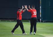 28 May 2022; David Delany of Munster Reds celebrates with Tyrone Kane of Munster Reds as he takes the first wicket for his side during the Cricket Ireland Inter-Provincial Trophy match between Munster Reds and Northern Knights at North Down Cricket Club in Comber, Down. Photo by George Tewkesbury/Sportsfile