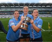 28 May 2022; Dublin players, from left, Jessica Tobin, Jennifer Dunne and Martha Byrne celebrate with the Mary Ramsbottom Cup after the Leinster LGFA Senior Football Championship Final match between Meath and Dublin at Croke Park in Dublin. Photo by Stephen McCarthy/Sportsfile