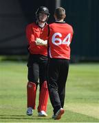 28 May 2022; PJ Moore of Munster Reds, left, celebrates with teammate Gareth Delany after taking his side's seventh wicket during the Cricket Ireland Inter-Provincial Trophy match between Munster Reds and Northern Knights at North Down Cricket Club in Comber, Down. Photo by George Tewkesbury/Sportsfile