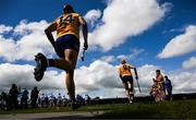 22 May 2022; David Fitzgerald of Clare followed by Peter Duggan, 14, run out for the Munster GAA Hurling Senior Championship Round 5 match between Clare and Waterford at Cusack Park in Ennis, Clare. Photo by Ray McManus/Sportsfile