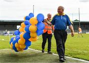 28 May 2022; Stewards John Ryan, right, and John Nelson, carry balloons past the pitch before the Tailteann Cup Round 1 match between Longford and Fermanagh at Glennon Brothers Pearse Park in Longford. Photo by Sam Barnes/Sportsfile