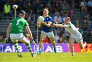 28 May 2022; Paudie Clifford of Kerry handpasses a point under pressure from Paul Maher and Limerick goalkeeper Donal O'Sullivan during the Munster GAA Football Senior Championship Final match between Kerry and Limerick at Fitzgerald Stadium in Killarney. Photo by Diarmuid Greene/Sportsfile