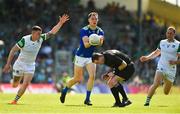 28 May 2022; Jack Barry of Kerry in action against Iain Corbett of Limerick handpasses the ball over referee Martin McNally during the Munster GAA Football Senior Championship Final match between Kerry and Limerick at Fitzgerald Stadium in Killarney. Photo by Diarmuid Greene/Sportsfile