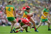 29 May 2022; Odhran McFadden Ferry of Donegal in action against Niall Loughlin, below, and Shane McGuigan of Derry during the Ulster GAA Football Senior Championship Final between Derry and Donegal at St Tiernach's Park in Clones, Monaghan. Photo by Ramsey Cardy/Sportsfile