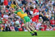 29 May 2022; Brendan Rogers of Derry kicks a first half point under pressure from Caolan McGonagle of Donegal during the Ulster GAA Football Senior Championship Final between Derry and Donegal at St Tiernach's Park in Clones, Monaghan. Photo by Ramsey Cardy/Sportsfile