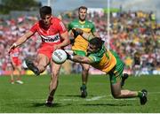 29 May 2022; Conor Doherty of Derry in action against Caolan McGonagle of Donegal during the Ulster GAA Football Senior Championship Final between Derry and Donegal at St Tiernach's Park in Clones, Monaghan. Photo by Stephen McCarthy/Sportsfile