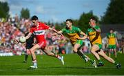 29 May 2022; Paul Cassidy of Derry in action against Eoghan Ban Gallagher and Aaron Doherty, right, of Donegalduring the Ulster GAA Football Senior Championship Final between Derry and Donegal at St Tiernach's Park in Clones, Monaghan. Photo by Stephen McCarthy/Sportsfile