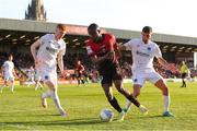 27 May 2022; Junior Ogedi-Uzokwe of Bohemians in action against Darragh Nugent, left, and Luke Heeney of Drogheda United during the SSE Airtricity League Premier Division match between Bohemians and Drogheda United at Dalymount Park in Dublin. Photo by Michael P Ryan/Sportsfile