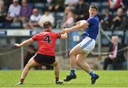 28 May 2022; James Smith of Cavan in action against Adam Lynch of Down during the Tailteann Cup Round 1 match between Cavan and Down at Kingspan Breffni in Cavan. Photo by Oliver McVeigh/Sportsfile