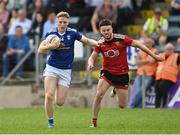 28 May 2022; Paddy Lynch of Cavan in action against Adam Lynch of Down during the Tailteann Cup Round 1 match between Cavan and Down at Kingspan Breffni in Cavan. Photo by Oliver McVeigh/Sportsfile