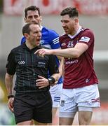 29 May 2022; Referee Derek O'Mahoney with James Dolan of Wesmeath and James Finn of Laois during the Tailteann Cup Round 1 match between Laois and Westmeath at MW Hire O'Moore Park in Portlaoise, Laois. Photo by Piaras Ó Mídheach/Sportsfile