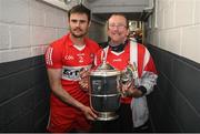 29 May 2022; Christopher McKaigue of Derry and a supporter bring the Anglo Celt Cup to the dressing room after the Ulster GAA Football Senior Championship Final between Derry and Donegal at St Tiernach's Park in Clones, Monaghan. Photo by Stephen McCarthy/Sportsfile
