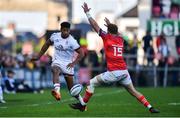3 June 2022; Robert Baloucoune of Ulster attempts a kick past Mike Haley of Munster during the United Rugby Championship Quarter-Final match between Ulster and Munster at Kingspan Stadium in Belfast. Photo by Ben McShane/Sportsfile
