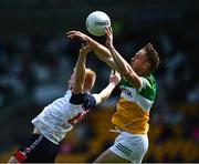 4 June 2022; Adrian Varley of New York in action against Declan Hogan of Offaly during the Tailteann Cup Quarter-Final match between Offaly and New York at O'Connor Park in Tullamore, Offaly. Photo by David Fitzgerald/Sportsfile
