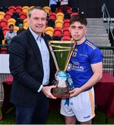 4 June 2022; Tipperary captain Daniel Rossiter is presented the cup by Ulster GAA President Ciarán McLaughlin after the Electric Ireland Challenge Corn Michael Hogan Final match between Galway and Tipperary at the National Games Development Centre in Abbotstown, Dublin. Photo by Ben McShane/Sportsfile