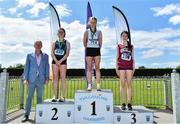 4 June 2022; President of the Irish Schools Athletic Association Billy Delaney, with junior girls triple jump medallists, from left, Ailbhe Steiger of St Marys New Ross, Wexford, silver, Clodagh Donoghue of St Marys Newport, Tipperary, gold, and Abbie Meany of Dominican College, Galway, bronze, at the Irish Life Health All Ireland Schools Track and Field Championships at Tullamore in Offaly. Photo by Sam Barnes/Sportsfile