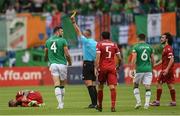 4 June 2022; Shane Duffy of Republic of Ireland is shown a yellow card by referee Radu Petrescu during the UEFA Nations League B group 1 match between Armenia and Republic of Ireland at Vazgen Sargsyan Republican Stadium in Yerevan, Armenia. Photo by Stephen McCarthy/Sportsfile