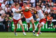 5 June 2022; Stefan Campbell of Armagh is tackled by Peter Harte, left, and Michael McKernan of Tyrone during the GAA Football All-Ireland Senior Championship Round 1 match between Armagh and Tyrone at Athletic Grounds in Armagh. Photo by Ben McShane/Sportsfile
