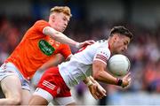 5 June 2022; Michael McKernan of Tyrone is tackled by Conor Turbitt of Armagh during the GAA Football All-Ireland Senior Championship Round 1 match between Armagh and Tyrone at Athletic Grounds in Armagh. Photo by Ben McShane/Sportsfile