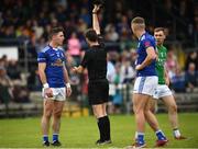 5 June 2022; Referee Paul Faloon hands out a black card to Killian Brady of Cavan during the Tailteann Cup Quarter-Final match between Fermanagh and Cavan at Brewster Park in Enniskillen, Fermanagh. Photo by Philip Fitzpatrick/Sportsfile