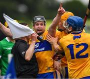 5 June 2022; The Clare captain Tony Kelly, together with teammates David Reidy and Shane O'Donnell, 12, challenge a line ball decision by standby referee and linesman Colm Lyons, during the Munster GAA Hurling Senior Championship Final match between Limerick and Clare at Semple Stadium in Thurles, Tipperary. Photo by Ray McManus/Sportsfile