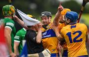 5 June 2022; The Clare captain Tony Kelly, together with teammates David Reidy and Shane O'Donnell, 12, challenge a line ball decision by standby referee and linesman Colm Lyons, during the Munster GAA Hurling Senior Championship Final match between Limerick and Clare at Semple Stadium in Thurles, Tipperary. Photo by Ray McManus/Sportsfile